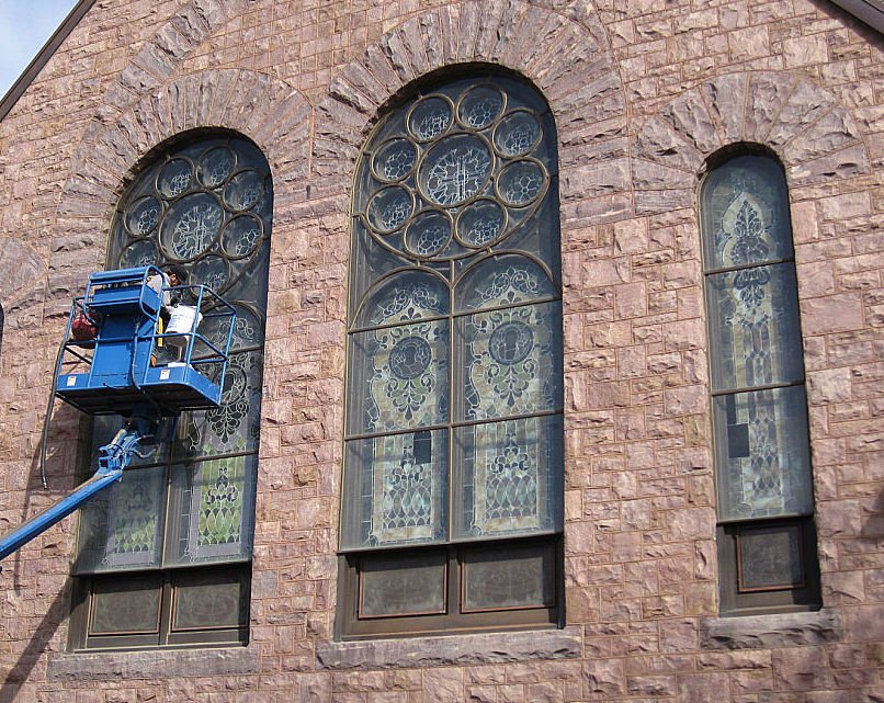 Workers installing window coverings